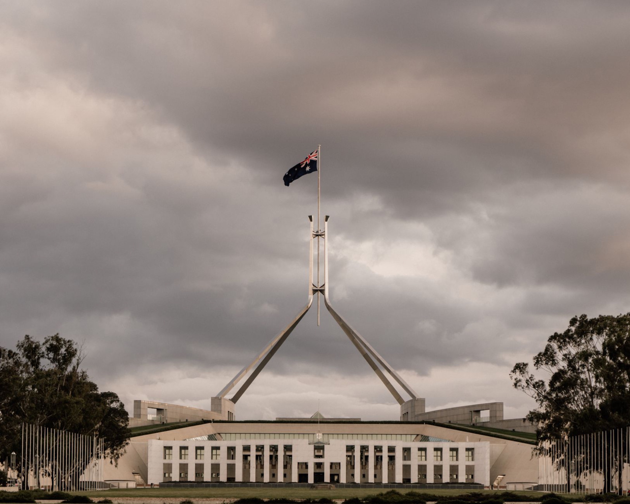 Australian Parliament House in Canberra beneath a clear sky